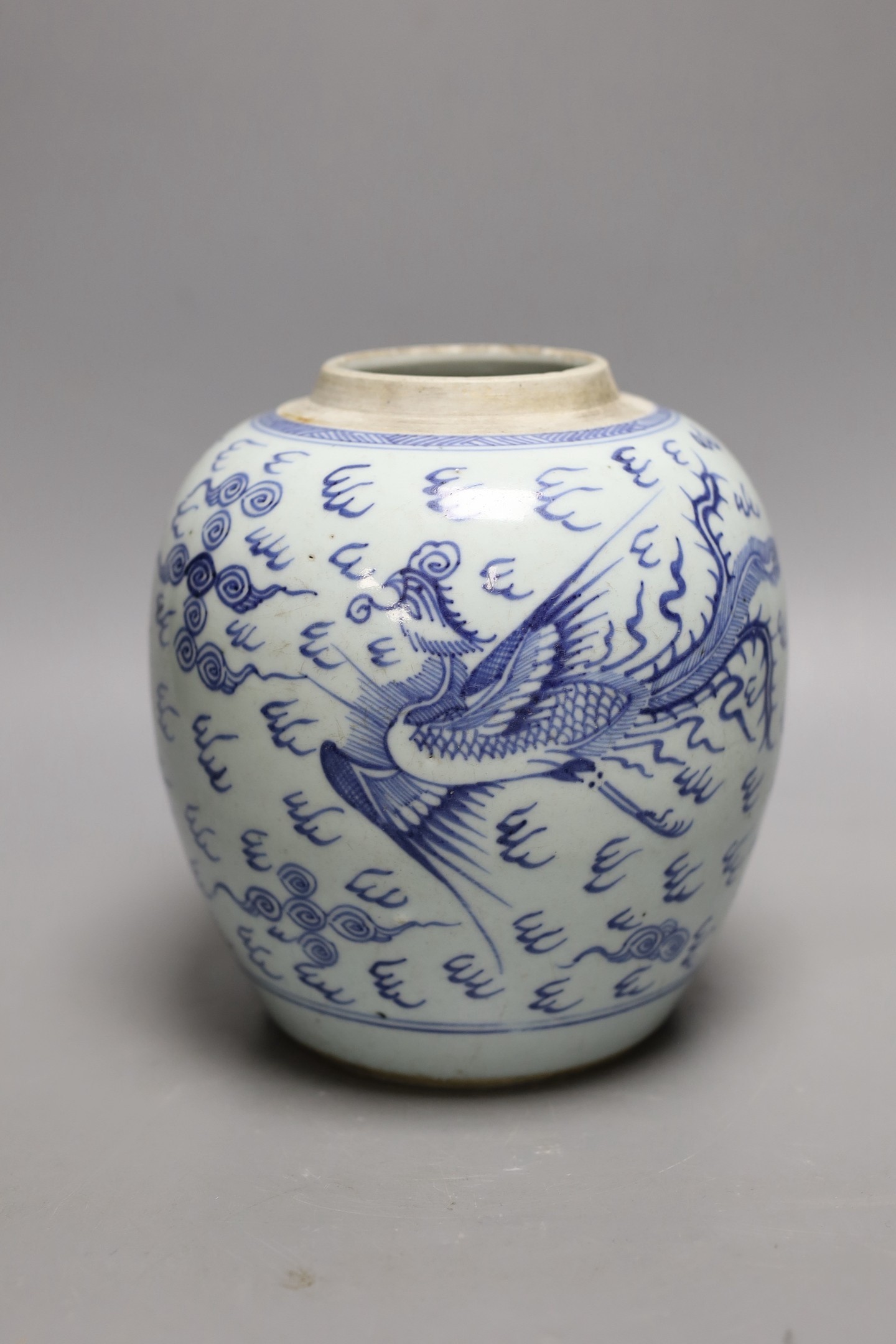 An 18th century Chinese provincial blue and white dragon and phoenix jar, 20cm high